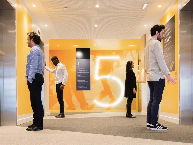 a group of people standing in a hallway